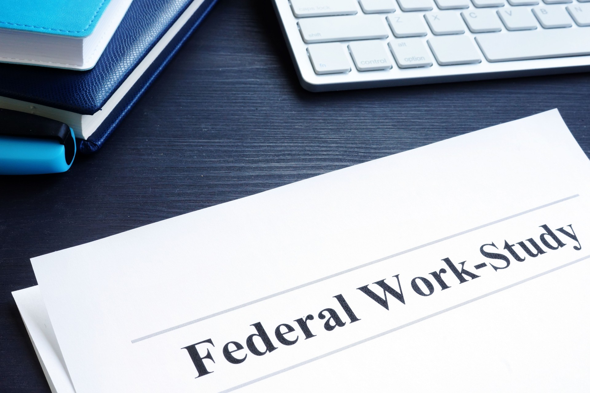 Federal Work Study FWS program documents and pen.